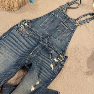 Distressed denim overalls